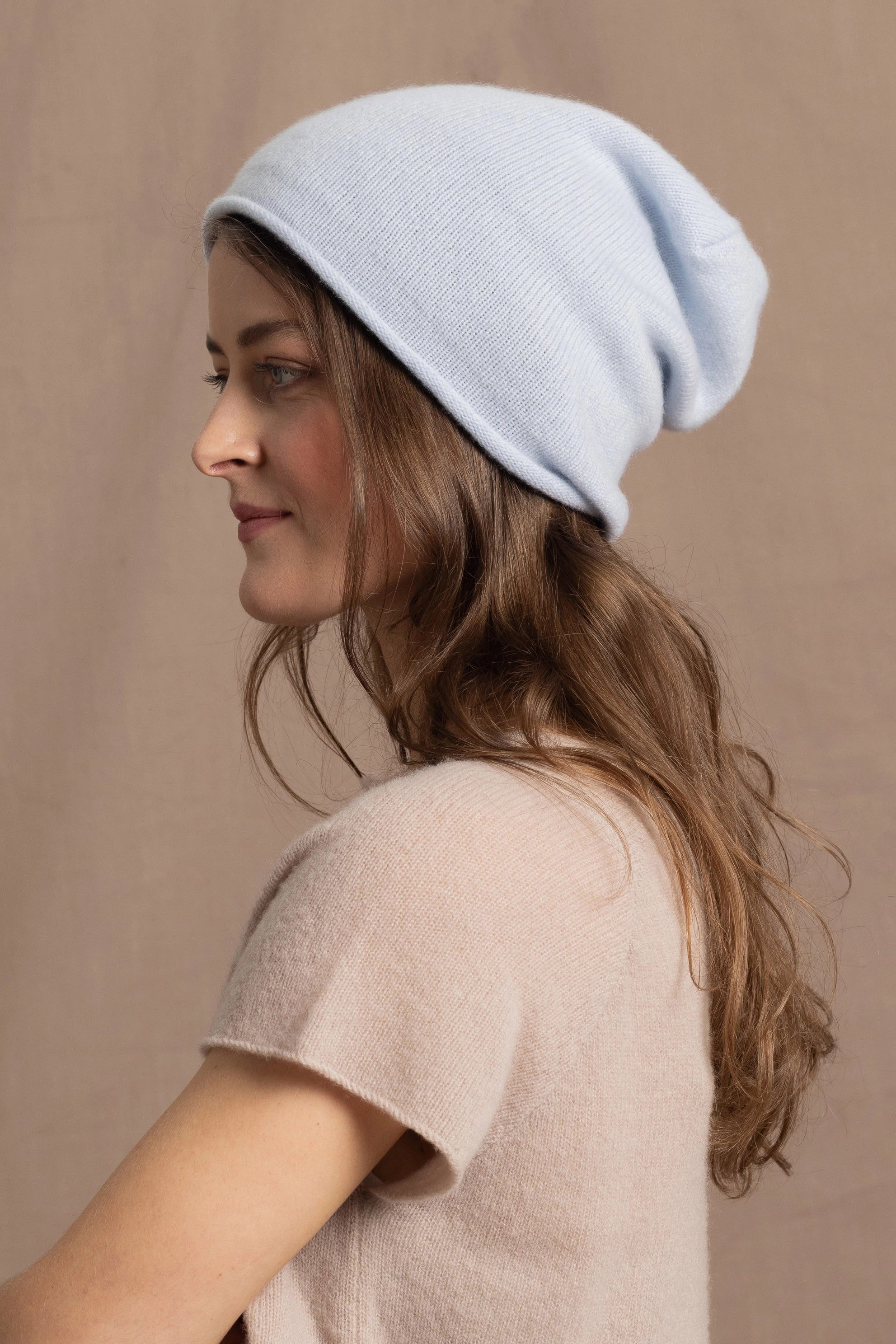 lady wears luxury cashmere beanie hat in pale blue