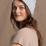 lady wears luxury cashmere beanie hat in pale blue