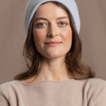 lady wears luxury cashmere beanie hat in pale blue
