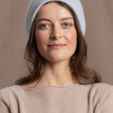 lady wears luxury cashmere beanie hat in pale blue