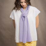 a woman wears a small cashmere scarf in light purple