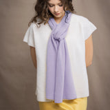 a woman wears a small cashmere scarf in light purple