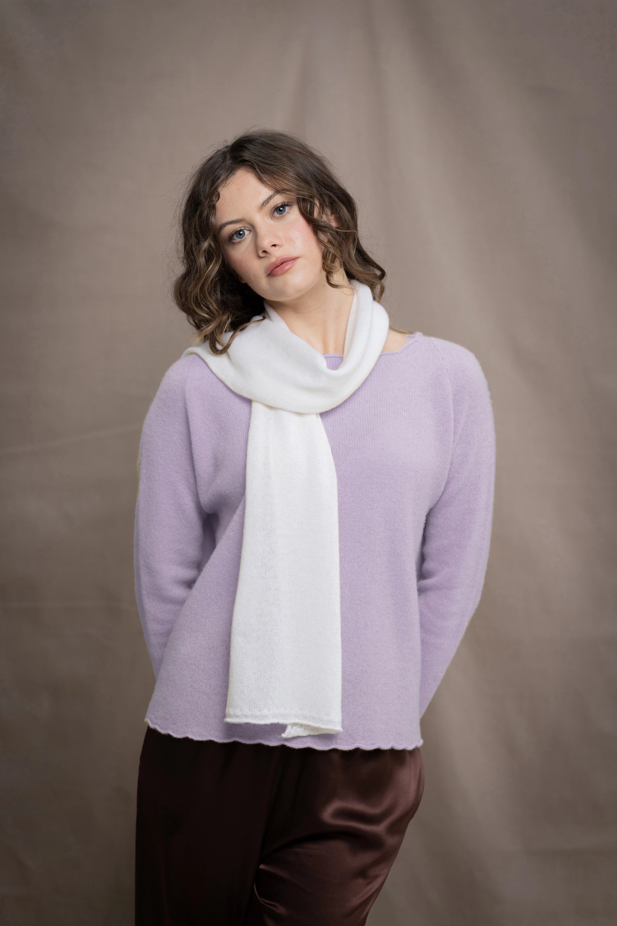 a woman wears a white cashmere scarf