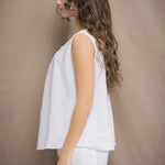 Woman wearing an Irish Linen sleeveless top and matching pants in white