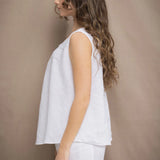 Woman wearing an Irish Linen sleeveless top and matching pants in white