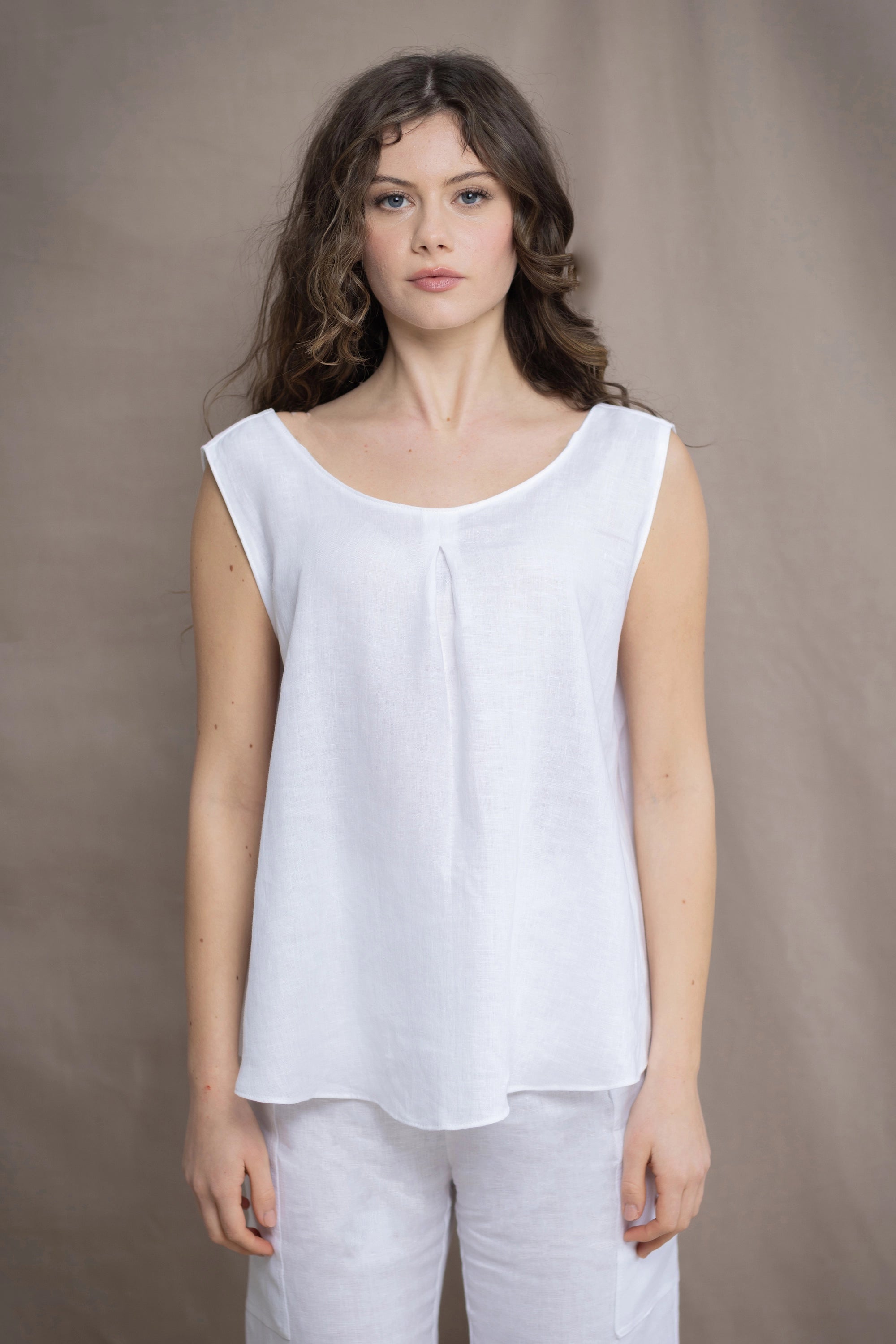 Woman wearing an Irish Linen sleeveless top and matching pants in white