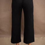 a woman wears a black wide leg Irish linen pants or trousers by Irish brand Madigan