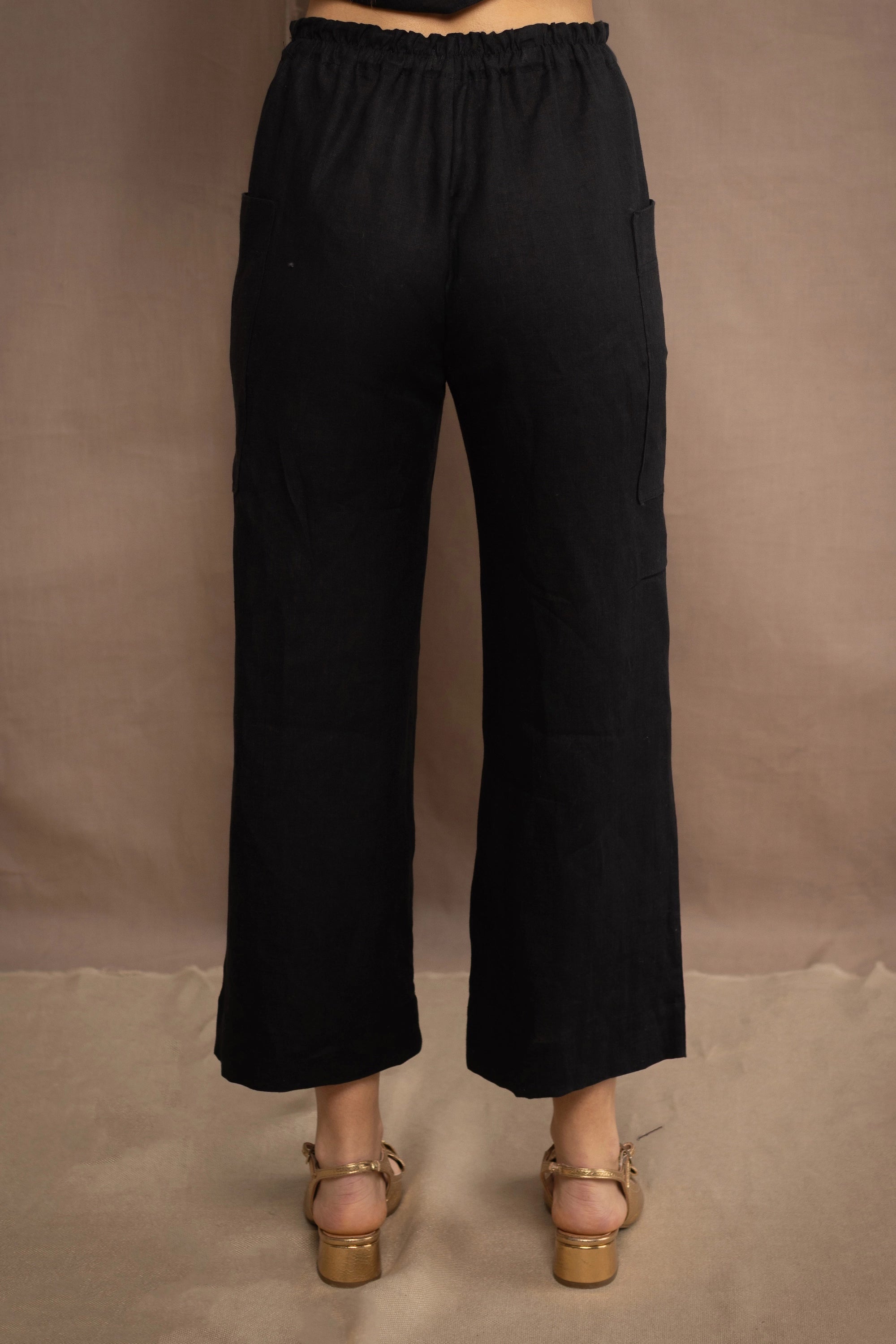 a woman wears a black wide leg Irish linen pants or trousers by Irish brand Madigan