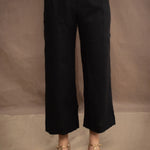 a woman wears a black wide leg Irish linen pants or trousers by Irish brand Madigan
