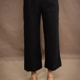 a woman wears a black wide leg Irish linen pants or trousers by Irish brand Madigan