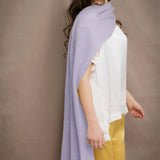 a woman wears a light purple cashmere wrap scarf by Irish brand Madigan