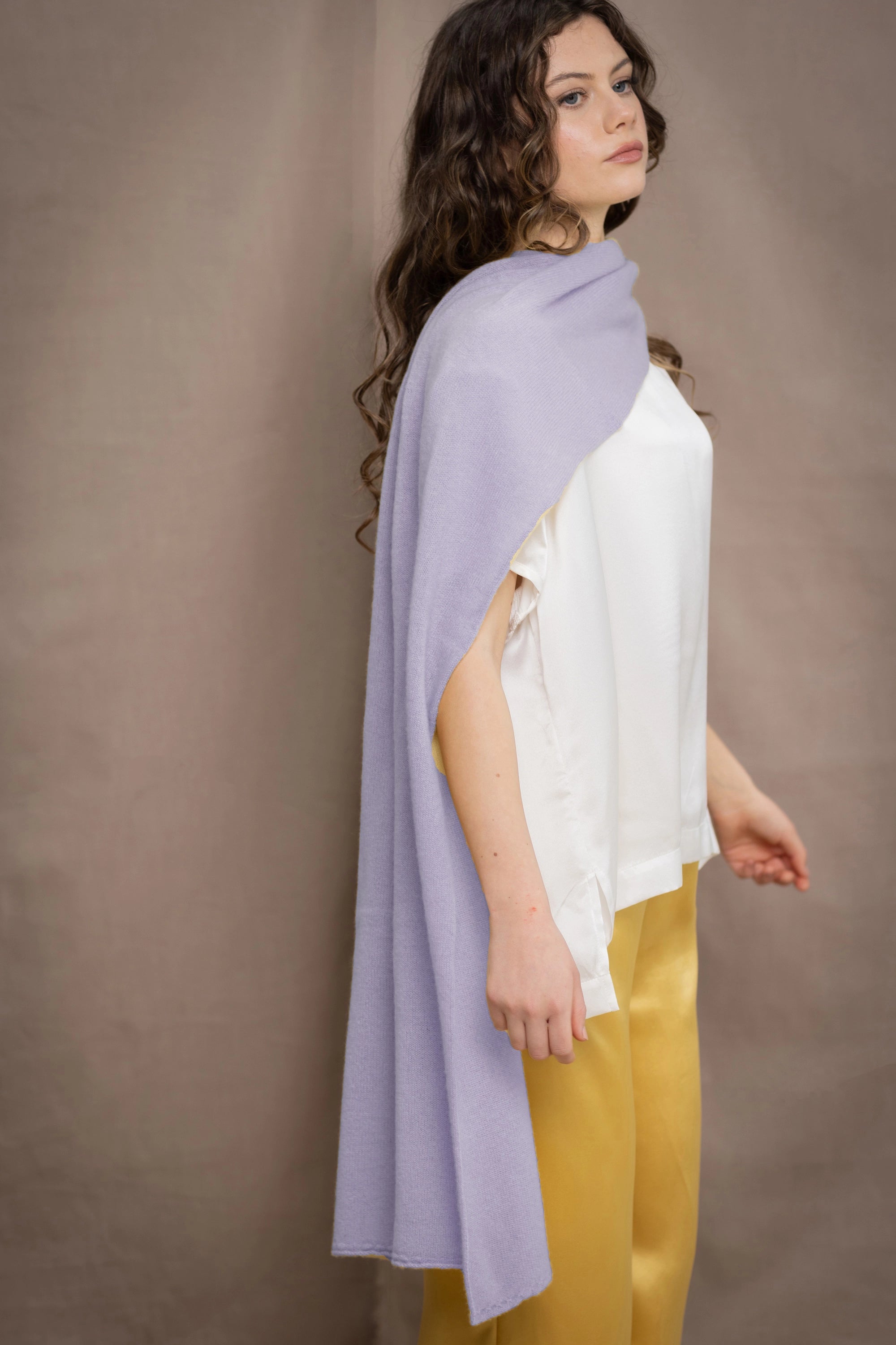 a woman wears a light purple cashmere wrap scarf by Irish brand Madigan