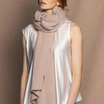 woman wearing a large cashmere wrap shawl in beige colour