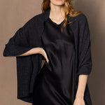 a woman wearing a large sparkling cashmere wrap shawl in black
