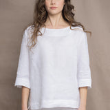 a woman wears a long sleeve pure Irish Linen top in white by Irish brand Madigan 