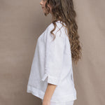 a woman wears a long sleeve pure Irish Linen top in white by Irish brand Madigan 