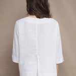 a woman wears a long sleeve pure Irish Linen top in white by Irish brand Madigan 