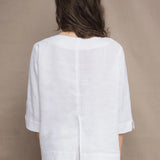 a woman wears a long sleeve pure Irish Linen top in white by Irish brand Madigan 