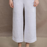a woman wears a pair of pure Irish linen Cropped trousers in white by Irish brand