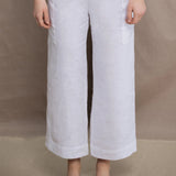 a woman wears a pair of pure Irish linen Cropped trousers in white by Irish brand