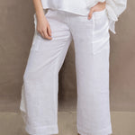 a woman wears a pair of pure Irish linen Cropped trousers in white by Irish brand