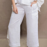 a woman wears a pair of pure Irish linen Cropped trousers in white by Irish brand