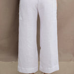 a woman wears a pair of pure Irish linen Cropped trousers in white by Irish brand