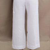 a woman wears a pair of pure Irish linen Cropped trousers in white by Irish brand