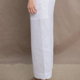 a woman wears a pair of pure Irish linen Cropped trousers in white by Irish brand