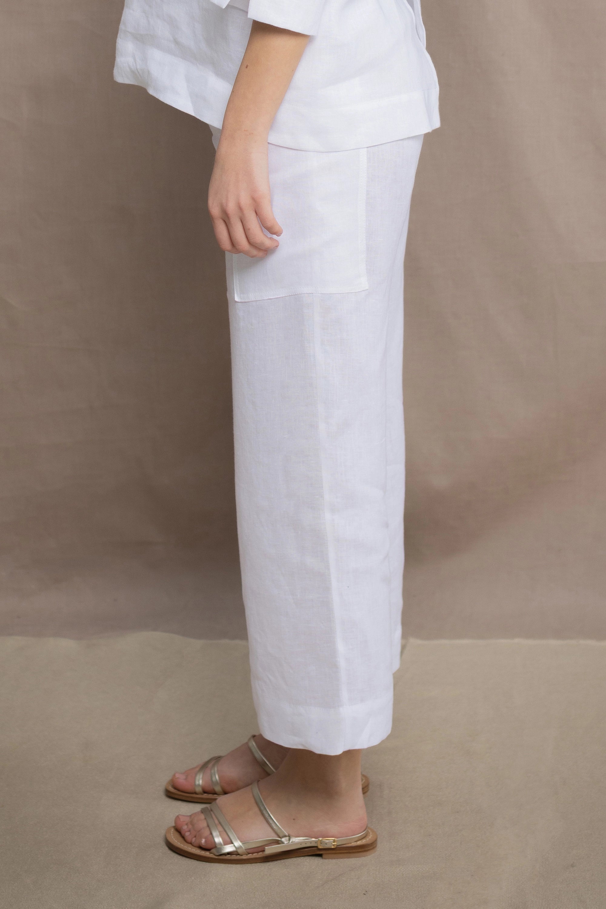 a woman wears a pair of pure Irish linen Cropped trousers in white by Irish brand