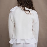 a woman wears a pure 100% cropped cashmere cardigan over an irish linen shirt in white