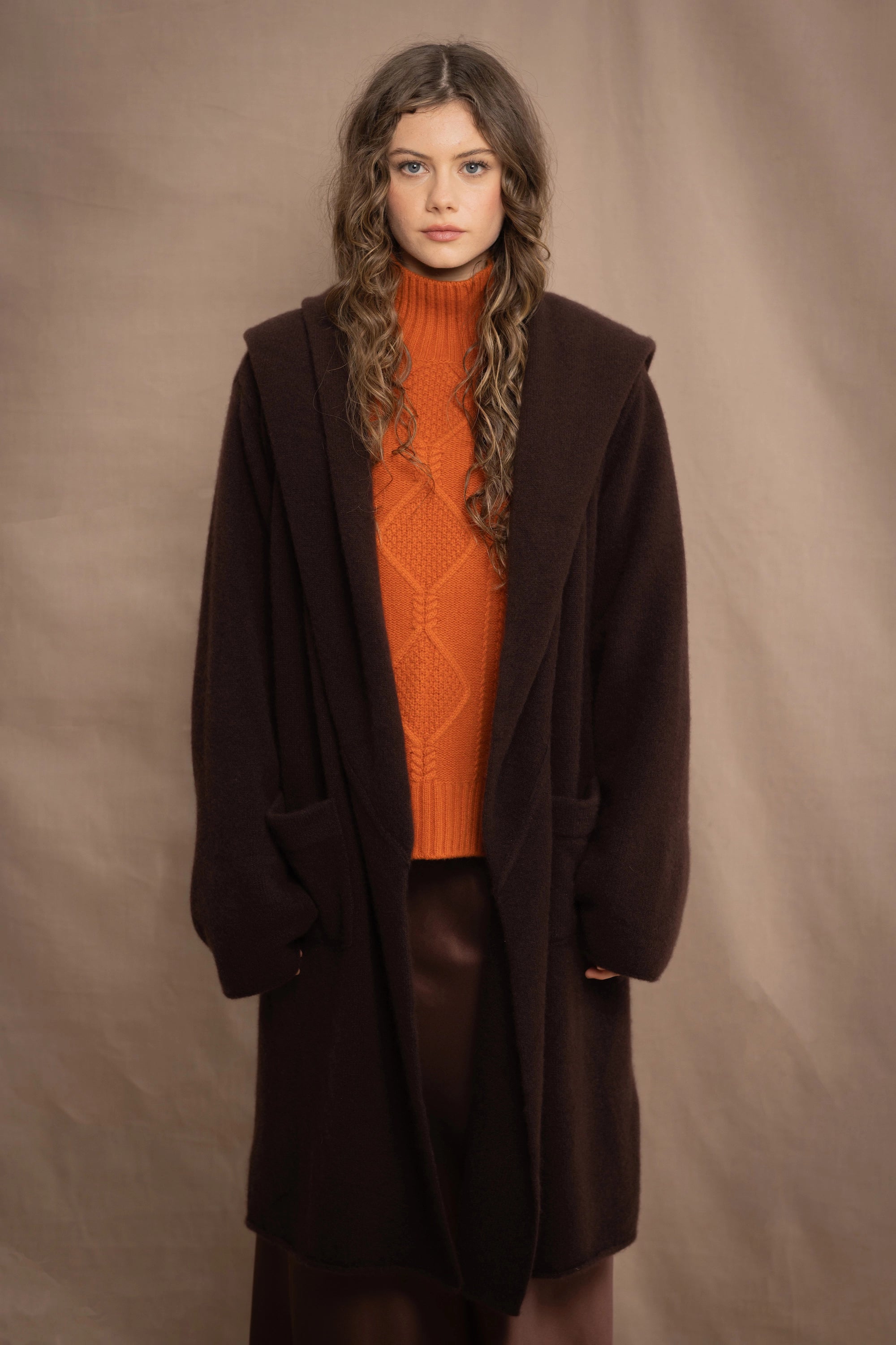 a woman wears a brown luxury cashmere coat in dark brown by Irish brand Madigan