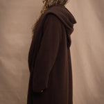 a woman wears a brown luxury cashmere coat in dark brown by Irish brand Madigan