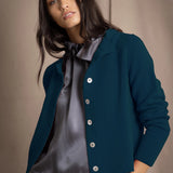woman wearing a teal cashmere cardigan over grey silk clothing