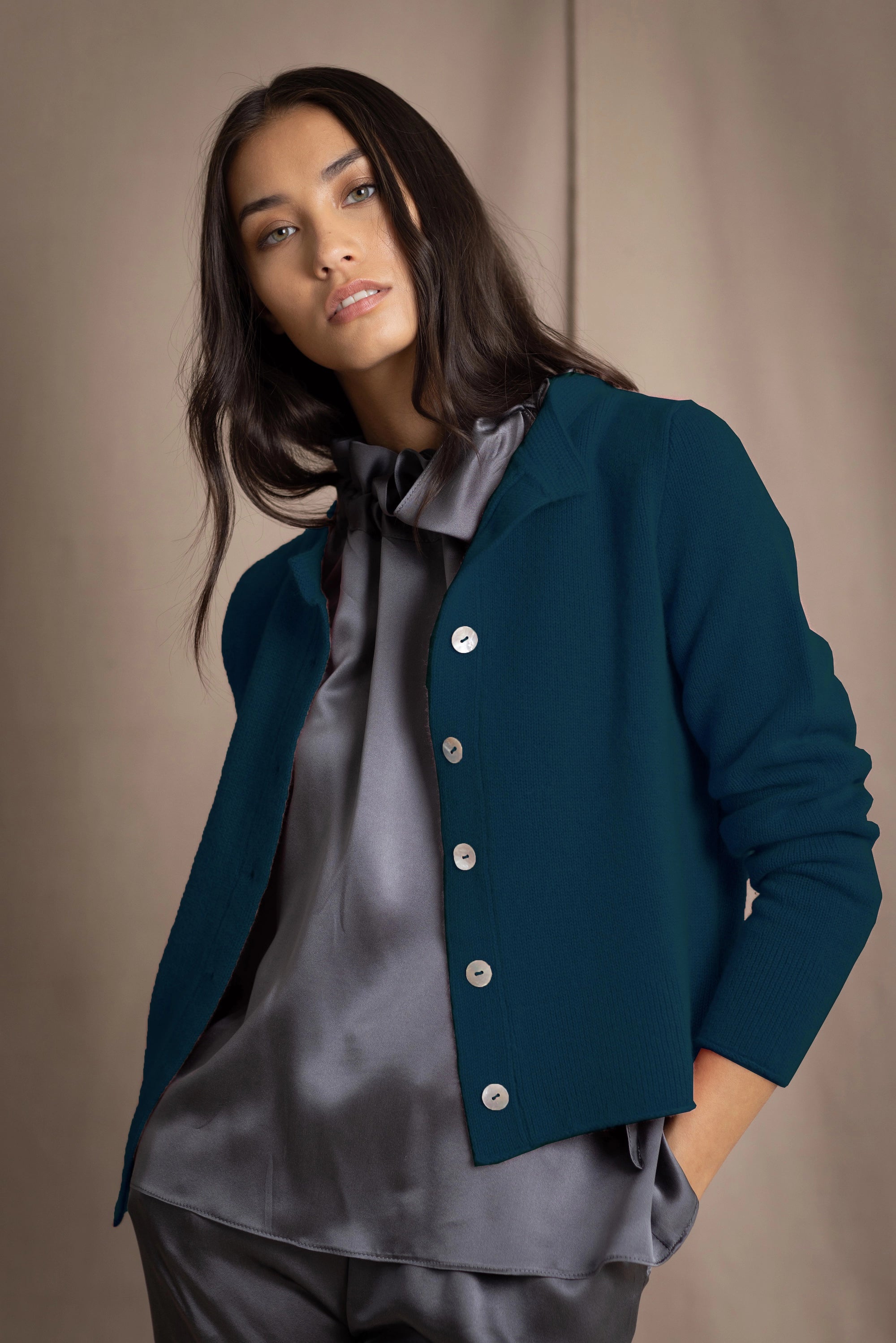 woman wearing a teal cashmere cardigan over grey silk clothing