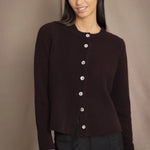 Woman wearing a dark brown cashmere cardigan with mother of pearl buttons