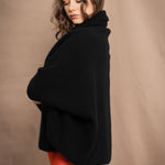 a woman wears a pure 100% cashmere cocoon cardigan in black 