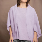 a woman wears a pure 100% cashmere cardigan in a cocoon shape with matching tee sweater in light purple over pewter silk skirt by Irish brand Madigan cashmere