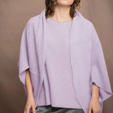 a woman wears a pure 100% cashmere cardigan in a cocoon shape with matching tee sweater in light purple over pewter silk skirt by Irish brand Madigan cashmere