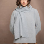 a woman wearing a light blue pure cashmere raglan sleeve sweater jumper and matching cashmere scarf over silk skirt in bronze