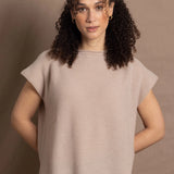 a woman wears luxury cashmere tee sweater in beige