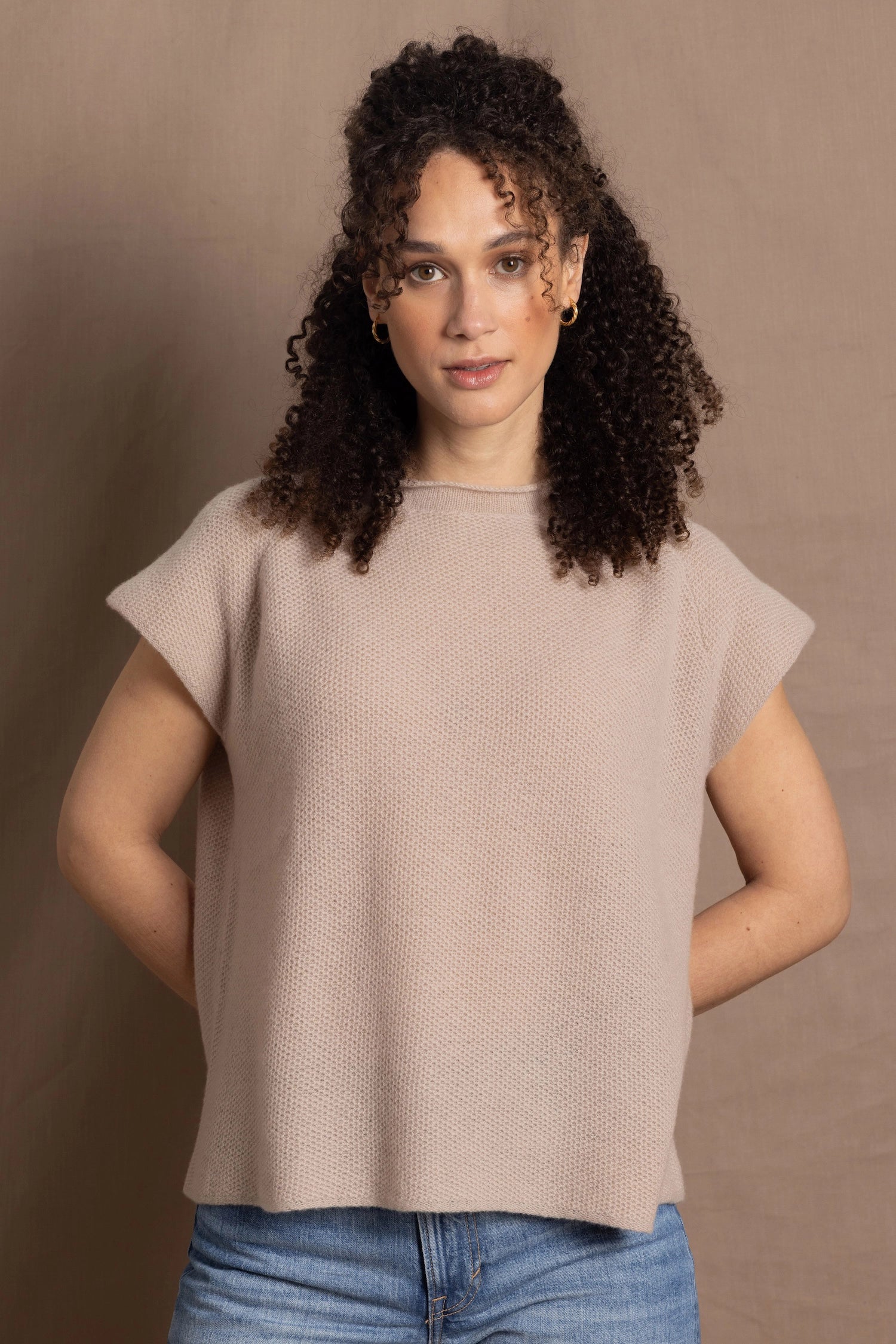 a woman wears luxury cashmere tee sweater in beige