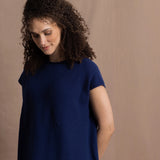 A lady wears a pure 100% cashmere tee sweater jumper in blue over bright pink silk trousers