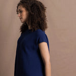 A lady wears a pure 100% cashmere tee sweater jumper in blue over bright pink silk trousers