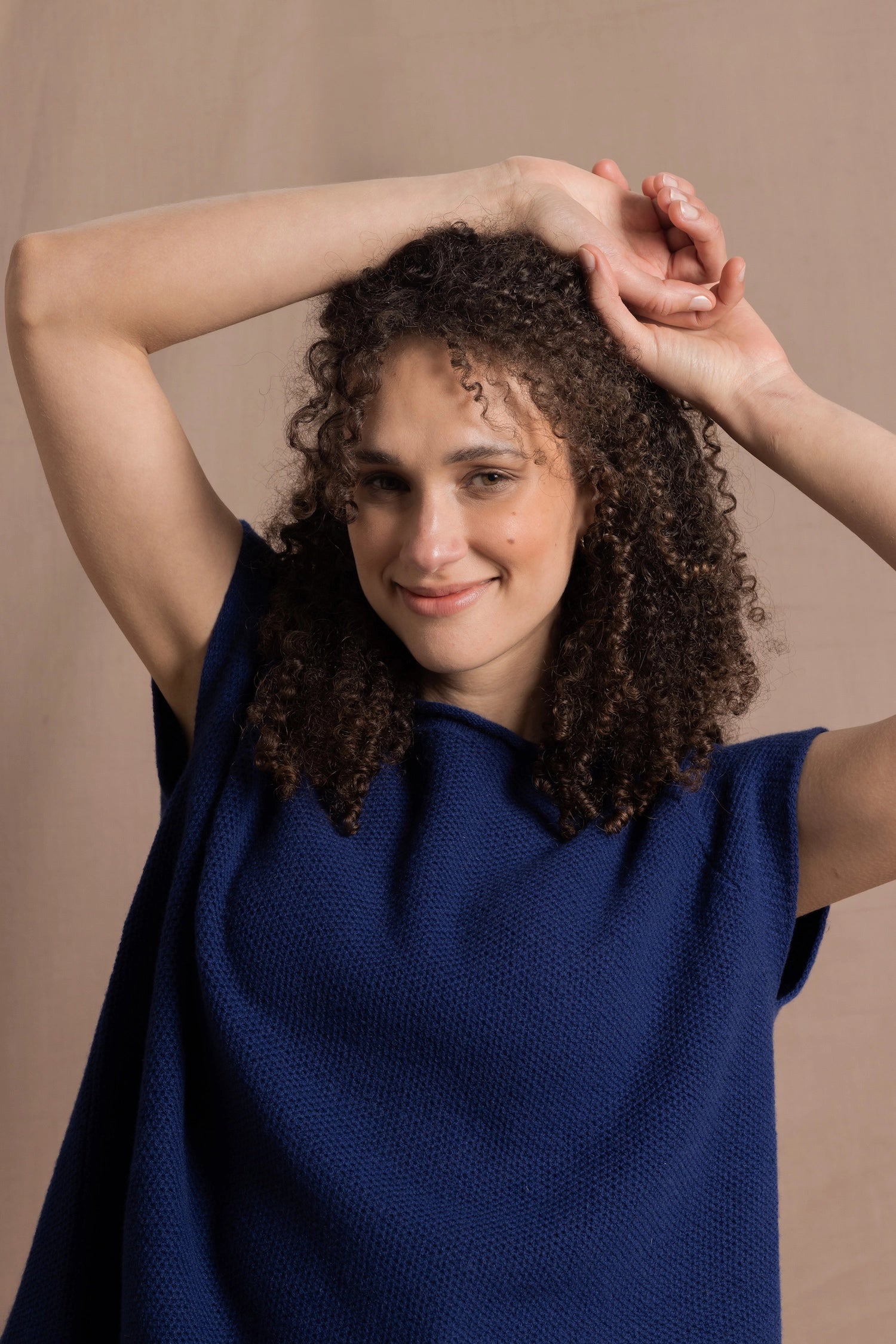 A lady wears a pure 100% cashmere tee sweater jumper in blue 