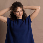 A lady wears a pure 100% cashmere tee sweater jumper in blue over bright pink silk trousers