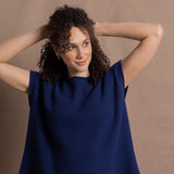 A lady wears a pure 100% cashmere tee sweater jumper in blue over bright pink silk trousers