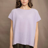 a woman wears a cashmere tee sweater with a moss texture in light pale purple