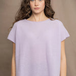 a woman wears a cashmere tee sweater with a moss texture in light pale purple