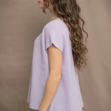a woman wears a cashmere tee sweater with a moss texture in light pale purple